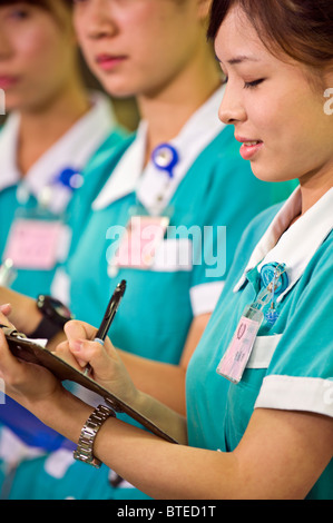 Nursing students taking notes in hospital Stock Photo