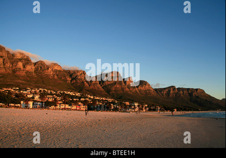Sunset at Camps Bay beach, with Twelve Apostles mountains in background Stock Photo