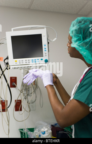Nurse checking medical equipment monitor Stock Photo