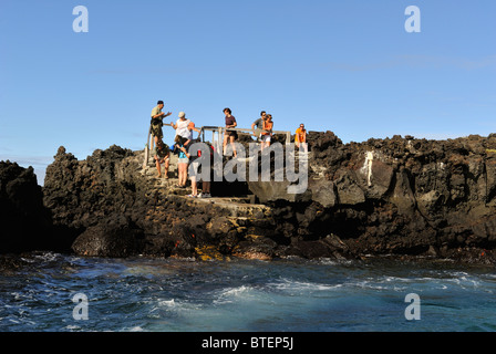 People waiting the boat on Bartolome Island, Galapagos, Ecuador Stock Photo