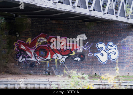 Graffiti on Brick Wall of Old Railway Bridge Stock Photo