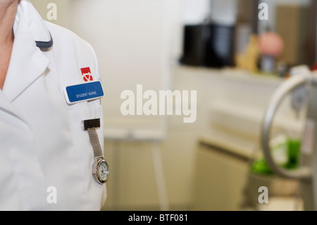 Close up of a nurse fob watch and university student nurse badge on a white uniform Stock Photo