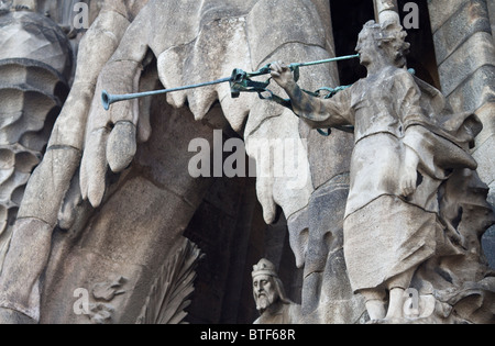 Sagrada Familia Cathedral by Gaudi - detail of the Nativity facade showing a statue of an angel blowing a trumpet Stock Photo