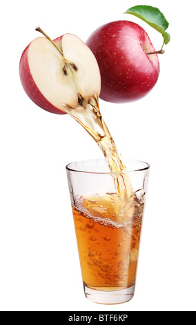 Fresh apple juice flowing from apple piece into the glass. Stock Photo