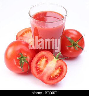 Fresh tomato juice and ripe tomatoes round glass. Stock Photo