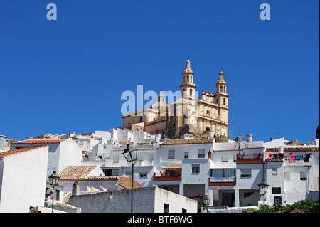 Townhouses with church to rear, pueblo blanco, Olvera, Cadiz Province, Andalucia, Spain, Western Europe. Stock Photo