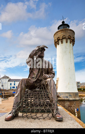 Fisherman statue and lighthouse in the harbour at Port Haliguen, Morbihan, Brittany, France, Europe Stock Photo