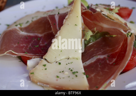 Gastronomy specialty,French cooking with dried ham, Sheep's milked cheese and tomato Stock Photo