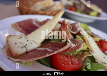 Gastronomy specialty, French cooking with dried ham, Sheep's milked cheese and tomato Stock Photo