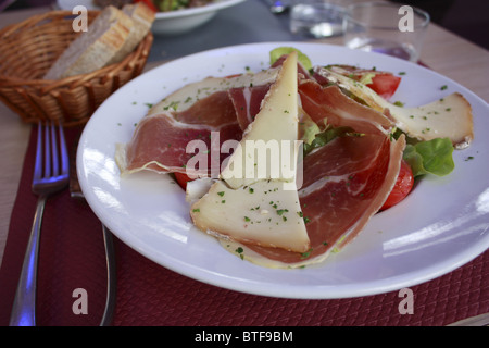 Gastronomy specialty,French cooking with dried ham, Sheep's milked cheese and tomato Stock Photo