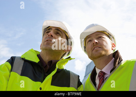 Building contractors discussing project outdoors Stock Photo