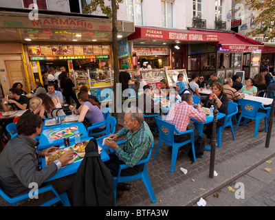 Typical busy ethnic pavement restaurant in the Marais district of Paris france Stock Photo
