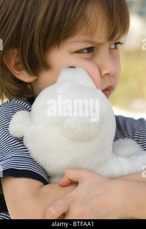 Little boy hugging teddy bear Stock Photo