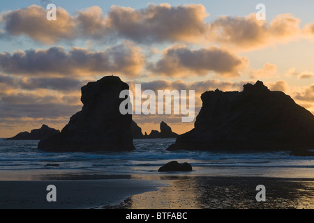 Seastacks at Coquille Point in the Oregon Islands National Wildlife Refuge silhouetted aganist a sunset sky in Bandon Oregon Stock Photo
