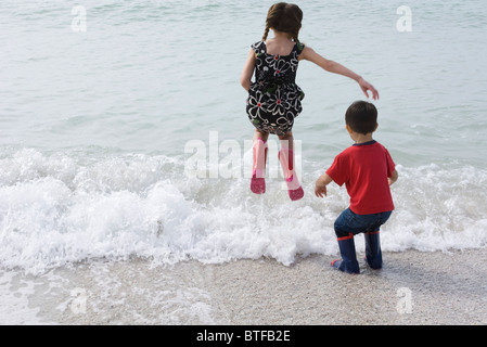 Children playing in surf at the beach