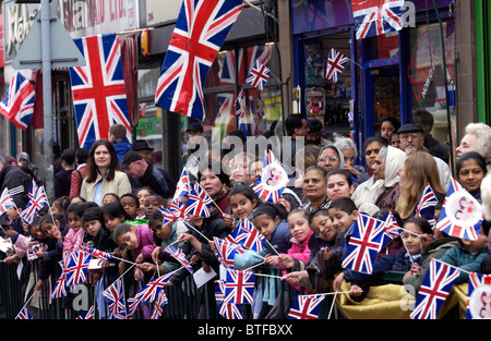 Crowds with Union Jack flags in Green Street in the East End of London Stock Photo