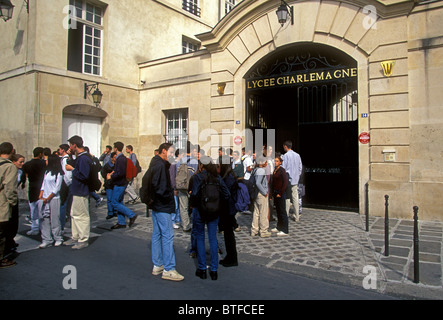 French high school students schoolboys and schoolgirls getting together at recess at Lycee Charlemagne in the Marais District in Paris France Stock Photo