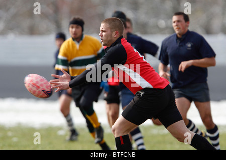 A Catholic University player passes the ball during a match against Georgetown at the annual Cherry Blossom Rugby Tournament. Stock Photo