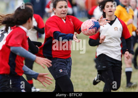 An American University player passes the ball against the University of Maryland during a women's rugby match. Stock Photo