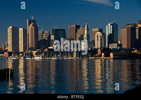 Morning sun shines on the downtown Boston harbor skyline as seen from Maverick Square, East Boston. Stock Photo