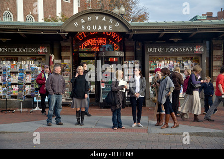 Local pedestrians wait in front of the news stand and subway station to cross Massachusetts Avenue in Harvard Square, Cambridge, Stock Photo