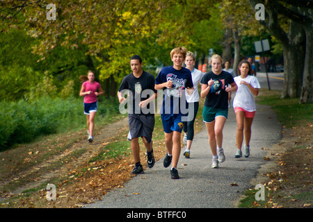 Students at a private prep school in Cambridge, MA, run along the Charles River during physical education class. Stock Photo