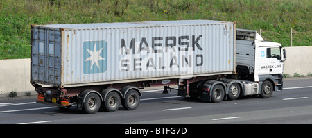 Maersk Sealand container load semi articulated trailer towed by Maersk Line company lorry truck Danish shipping logistics business on M25 UK motorway Stock Photo