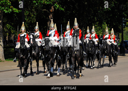 Life Guards Household Cavalry Mounted Regiment soldiers red uniform with cuirass arriving changing guard duty Horse Guards Parade London England UK Stock Photo