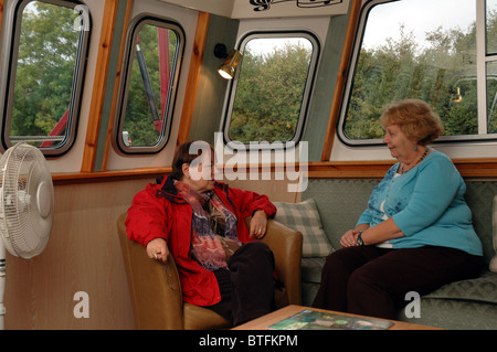 Passengers in the bar on board the English river cruiser MV Edward Elgar on the Gloucester and Sharpness canal Stock Photo