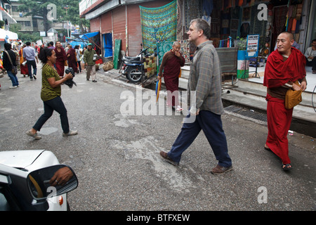 A daily life street scene with tourists and Tibetan people and monks in McLeod Ganj, India Stock Photo