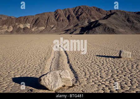 Sailing stones or sliding rocks mysteriously move across The Racetrack Playa in Death Valley National Park, California USA. Stock Photo
