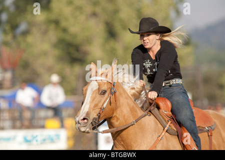 Cowgirl Chris Azevedo competes in the Barrel Race event at the San Dimas Rodeo in San Dimas on October 2, 2010. Stock Photo