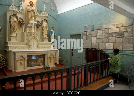 A pilgrim woman praying in brother's Andre chapel at Saint Joseph's Oratory in Montreal Stock Photo