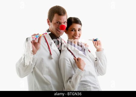 Male and female doctors with party toys Stock Photo