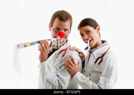 Male and female doctors with party toys Stock Photo