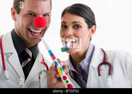 Male and female doctors with party toys Stock Photo