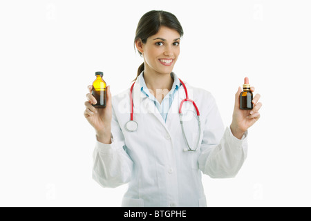 Doctor holding medicine bottles Stock Photo