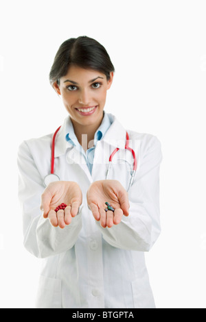 Doctor holding pills in each hand Stock Photo