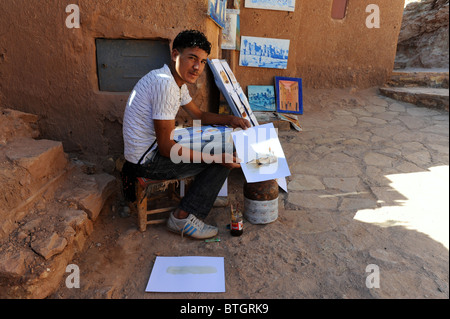 Man selling paintings in Ait Benhaddou, the spectacular fortified town in Southern Morocco. Stock Photo