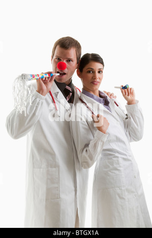 Male and female doctors with party toys Stock Photo