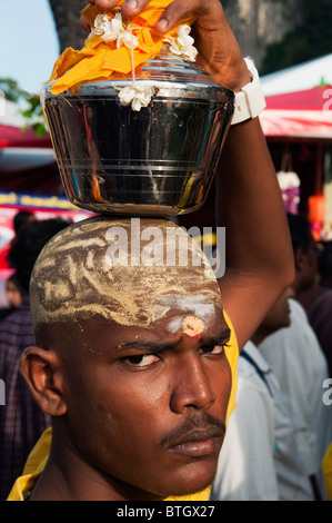 Hindu devotee carrying a lota with water during Thaipusam Festival at Batu Caves. Stock Photo