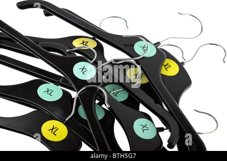 Pile of plastic XL black coat hangers Stock Photo