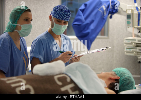 Doctors with patient in the operating room before a surgery Stock Photo