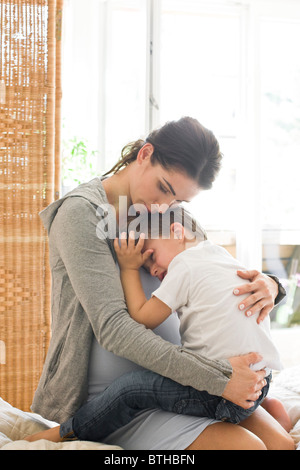 Mother hugging sad son Stock Photo - Alamy