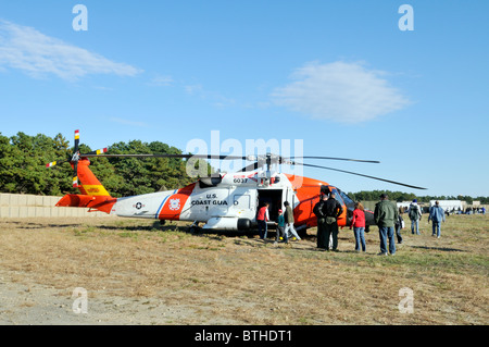 One of Air Station Cape Cod United States Coast Guard search and rescue Jayhawk helicopters stationary on the ground. Stock Photo