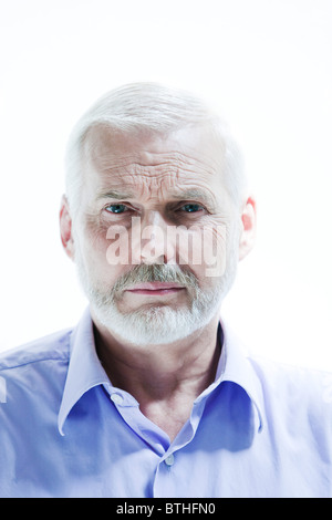 caucasian senior man portrait sullen isolated studio on white background Stock Photo