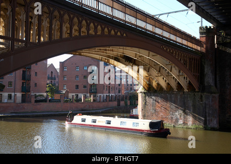Narrow boat under bridge in Castlefield Manchester UK Stock Photo