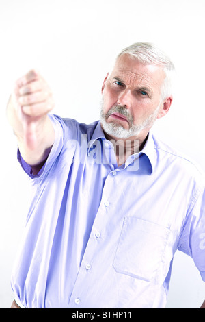 caucasian senior man portrait thumb down failure isolated studio on white background Stock Photo