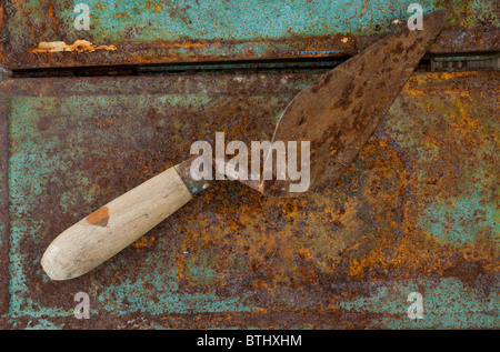 Bricklayers Trowel on a rusty background Stock Photo