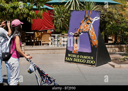 A young girl gets her picture taken at the SAN DIEGO ZOO - CALIFORNIA Stock Photo